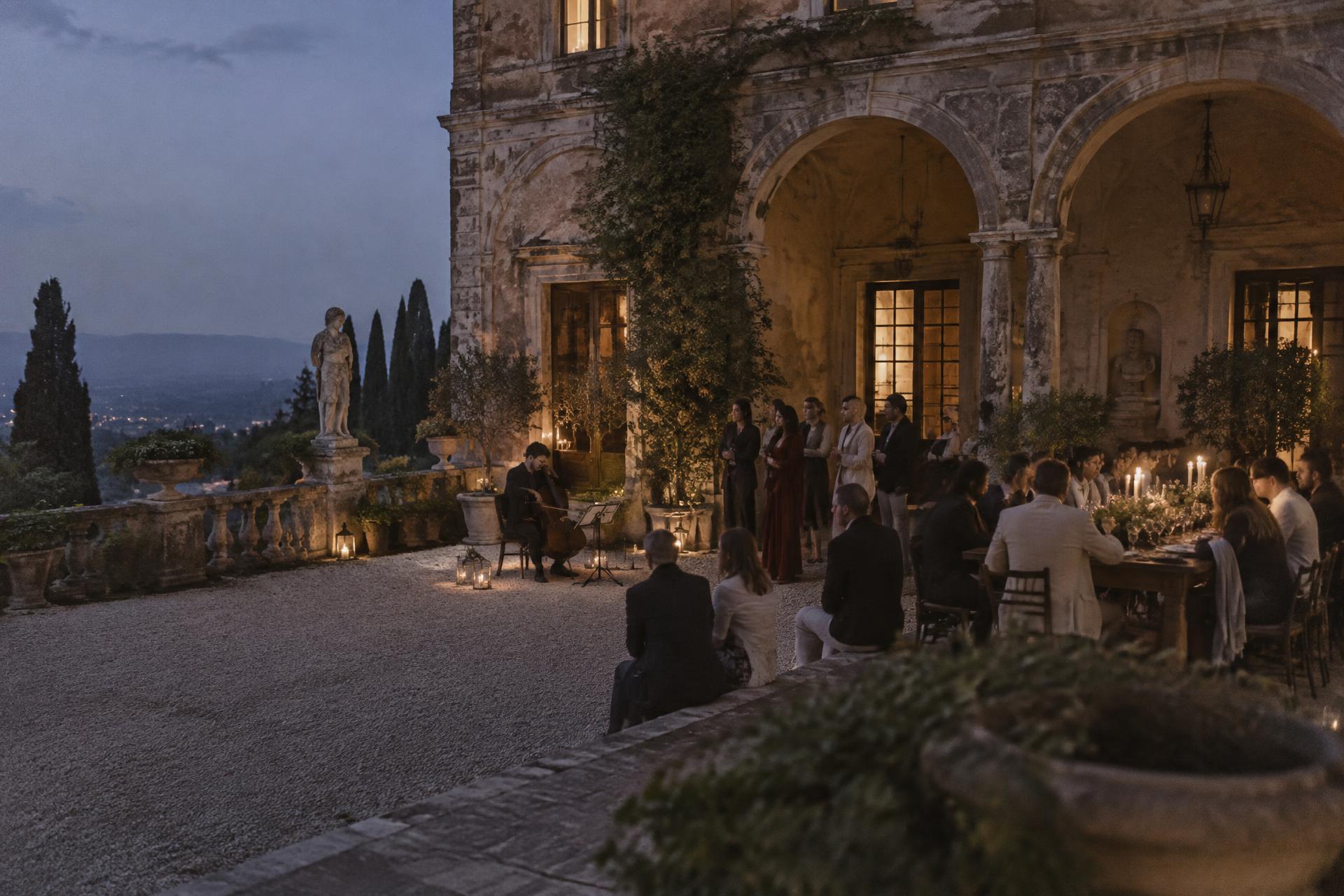Guests gathering in a historic Italian courtyard